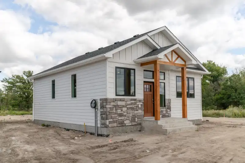 Square frame Houses on a sunlit suburb neighborhood against cloudy blue sky and mountain
